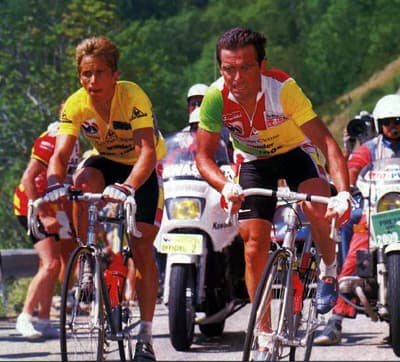 Bernard Hinault in the combination jersey climbing beside Greg LeMond in yellow at the 1986 Tour