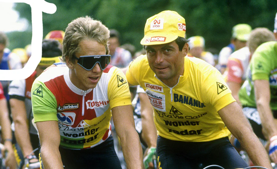 Greg LeMond in the combination jersey riding alongside Bernard Hinault in yellow, both La Vie Claire