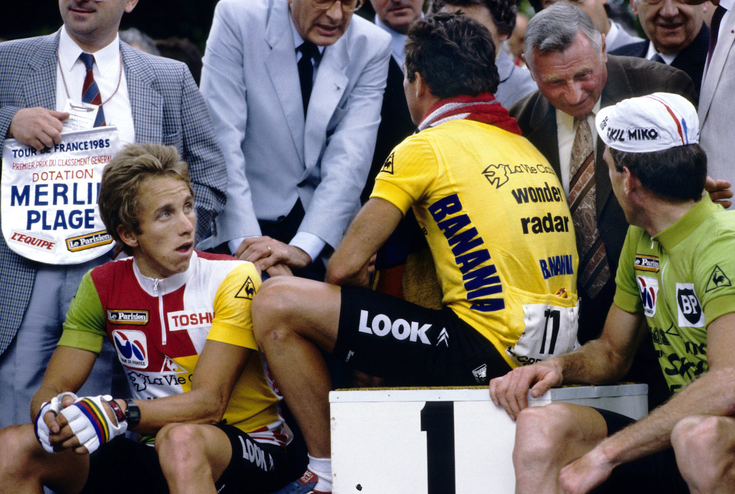 The 1985 Tour podium: Greg LeMond in the combination jersey seated beside Bernard Hinault in yellow